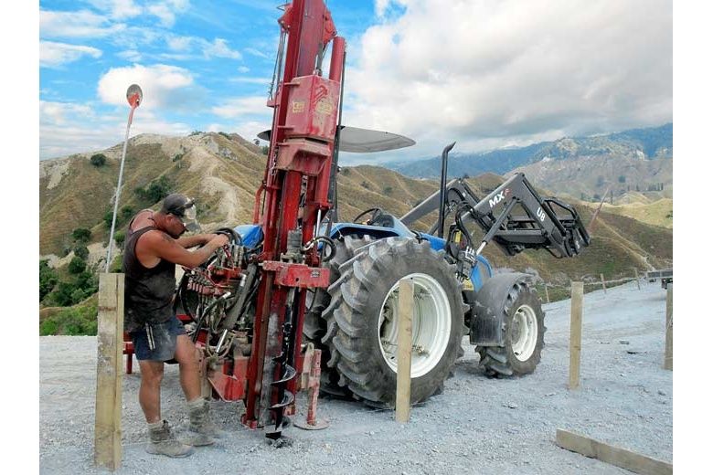 Fencetech drilling holes in hard Stoney driveway on hills