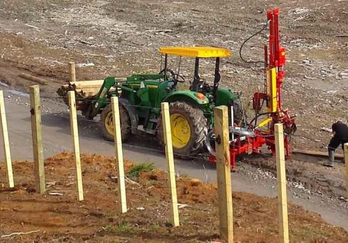 New batten fence constructed by fencing contractor with fence posts on front forks